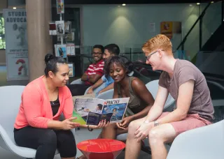 Students reading a magazine together