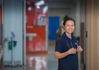 Woman in scrubs looking confident