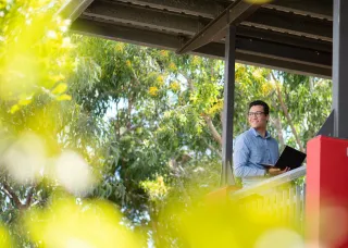 CDU student with a laptop looking confident