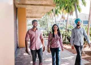 3 International students walking on campus