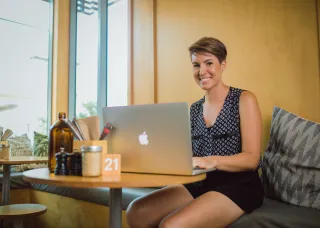 Arts student Ally studying online in a cafe