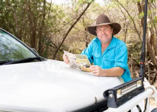 Conservation and ecosystem management lecturer next to a 4wd vehicle