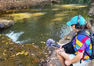 Researcher Jen Macdonald takes sound recordings of Rapid Creek waters