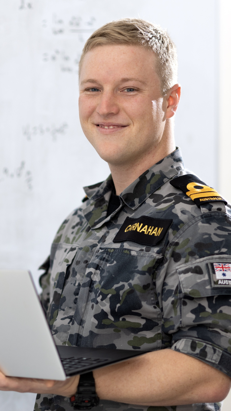 Australian Defence Force staff member standing in front of white board