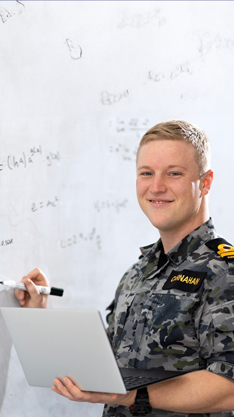 Defence student in front of whiteboard