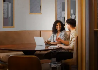 Woman and man in office meeting space