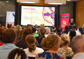 Professor Kim Humphrey speaking at the Positive Duty event in 2024