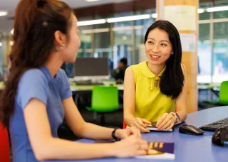 Woman smiling sitting at desk
