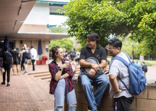 Group of three students interacting on the Casuarina campus