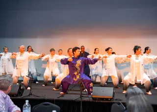 people performing tai chi on stage
