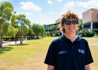 young man in sunglasses with CDU Open day written on the lenses