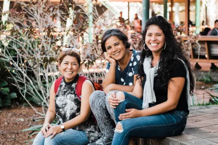 Seated international students near basketball court