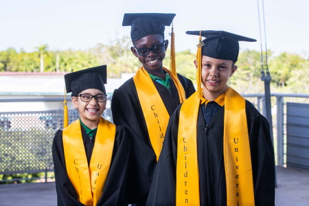 Jasnam Kaur, Daniel Mbemap and Latoya Djumadi celebrate learning at graduation