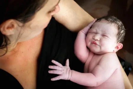 Woman with infant in hand