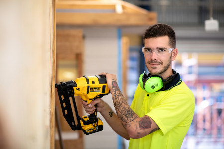 male apprentice using a power tool