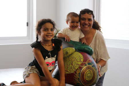 :  Participant and midwife in the Birthing in Our Community program in Brisbane’s southern suburbs, Kyleigh Brown-Lolohea, with her daughters and belly cast made during her pregnancy