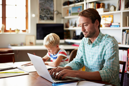 Father with son studying online from home