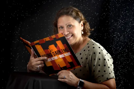 Dr Tracy Woodroffe holding book 