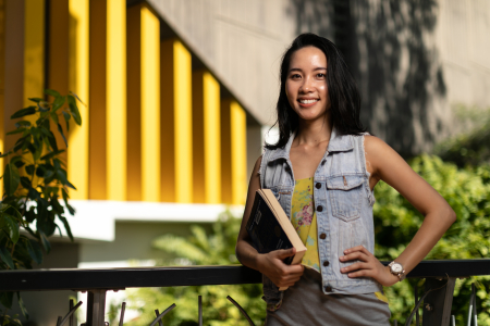 MBA student Ellie holding book on campus