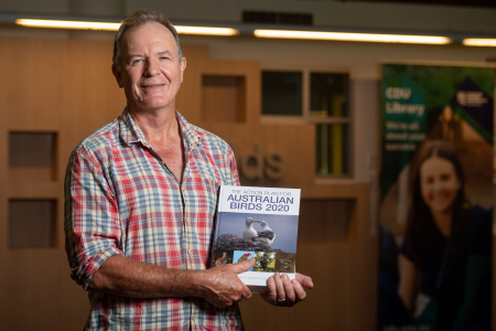 CDU Conservation Professor Stephen Garnett with the Action Plan for Australian Birds 2020 book he edited that identified 216 threatened birds in Australia.