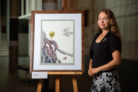 Anastasia Maksimova with the Spotted Mangrove botanical painting that is being exhibited in Kew.