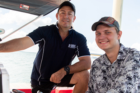 Maritime instructor Robert Kelly with high school student Matthew Jenko on CDU's training boat on Darwin Harbour.