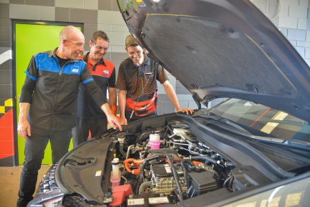 Former CDU student and The Dent Pusher Director David Eves and Prompt Auto Repairs Director Scott Petschel complete training with MTA training assessor Steve Richardson at CDU as part of a new hybrid vehicle training course held at the Casuarina campus.