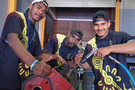 Young First Nations men working on Valiant car