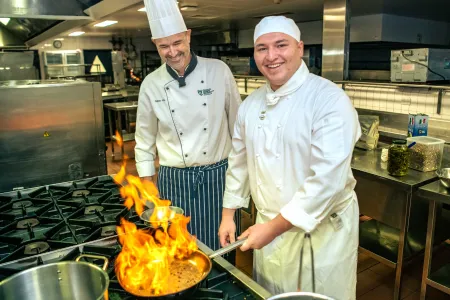  Darwin local and Charles Darwin University (CDU) Certificate III in Commercial Cookery student Stellio Ginis is putting his cooking skills to the test as he prepares to represent Australia at the Culinary Olympics in 2024.  Pictured; Stellio Ginis CDU Senior VET Lecturer in Culinary Arts Jason Wilkes