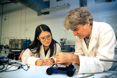 Charles Darwin University (CDU) Science lecturer Stephen Reynolds and graduate Yunzhu Wang construct a solar-powered car, a task that will feature in the new science and technology elective offered to arts and humanities students.