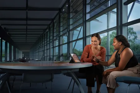 students sitting around a laptop