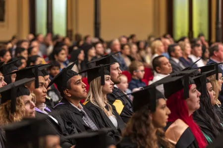 graduates sit at town hall