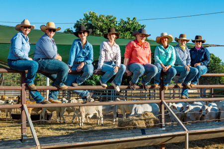 Team photo on cattle fence