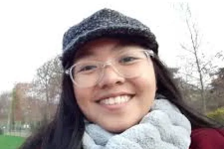 Angelina Aquino - young filipino woman smiling wearing glasses, cap and scarf