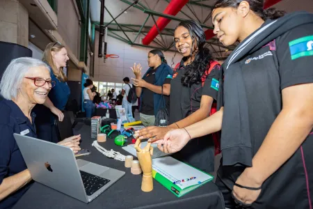 Students exploring stalls at the Faculty of Health expo.