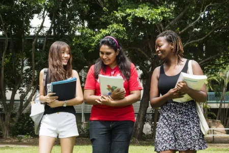 Three students walking outdoors