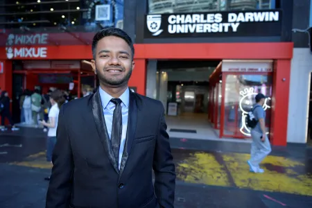 Jabir standing in front of CDU sign 