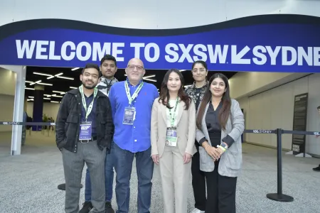 Students stand in front of innovation expo