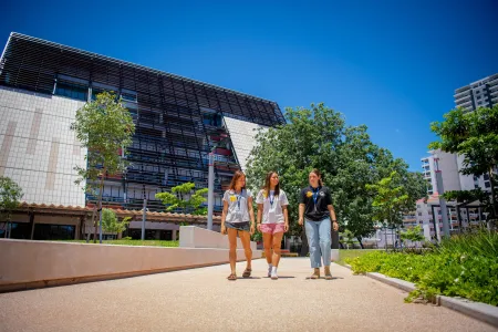 Three students walking with Danala | ECP building in the background