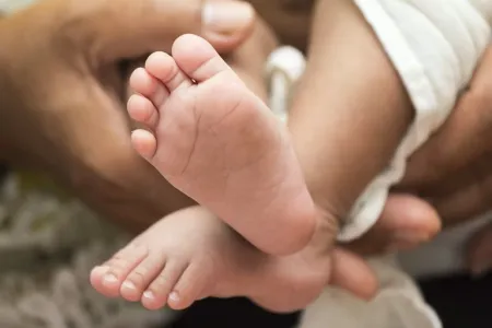 First Nations Parent Holding Babies' Feet