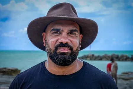 Yolngu man stands in front of jetty