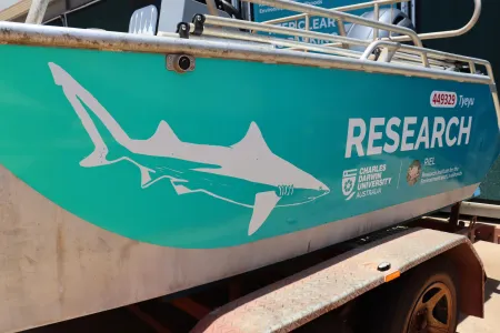 CDU-branded aquatic research vessel (boat) with shark print on side