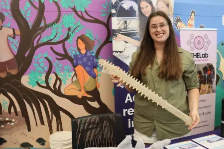 Woman holding the nose bone of a sawshark