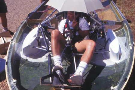 young man sitting inside the solar car created for the Desert Rose race