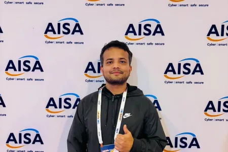 student gives thumbs up in front of AISA sign