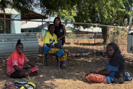 Ground Up researcher Melanie Cook (left) sitting with family in Ngangmarriyanga. Picture: Michaela Spencer
