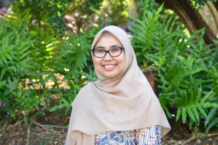 Portrait of Nur Isiyana Wianti standing in a garden
