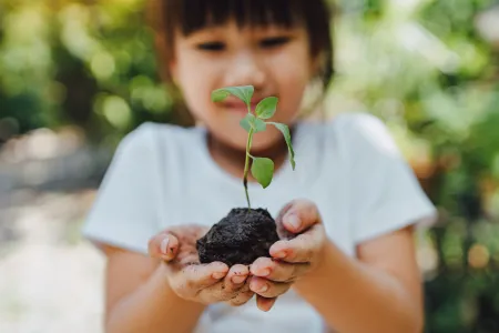 girl holding plant 