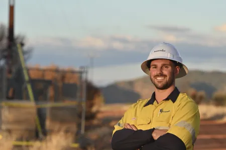 Male tradesperson standing in front of power lines