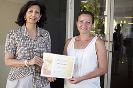 CDU Library Research Services Coordinator Jayshree Mamtora (left) presents the scholarship to Donna Robbins